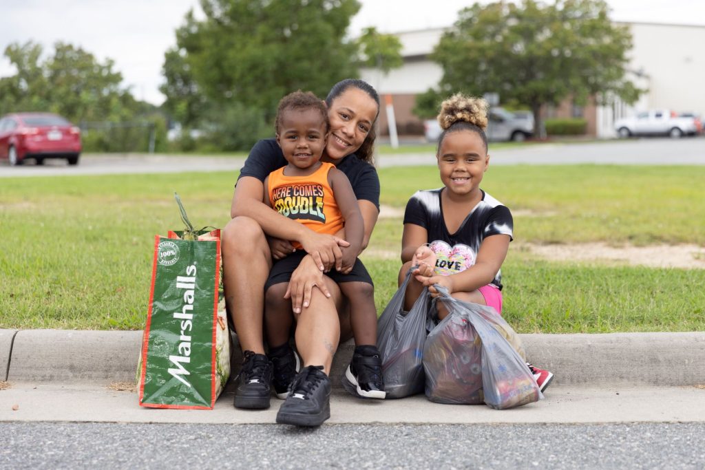 A mother with her two children hanging out after attending a School Market
