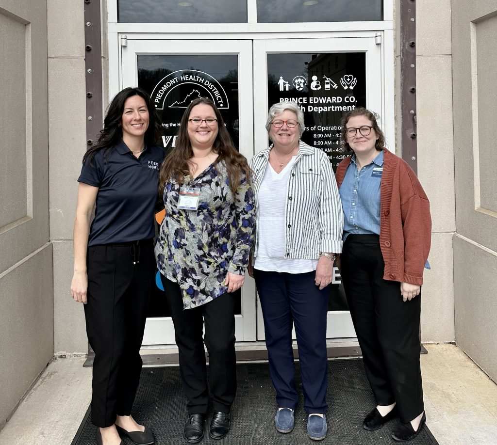 Four women standing outside the Prince Edward County Health Department, representing Feed More's partnership efforts and additional resources.