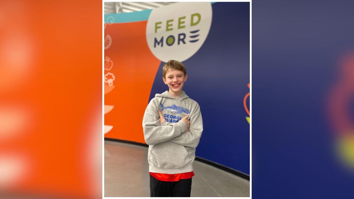 Photo of a generous soul named Alex standing in Feed More after delivering donations from his birthday fundraiser.