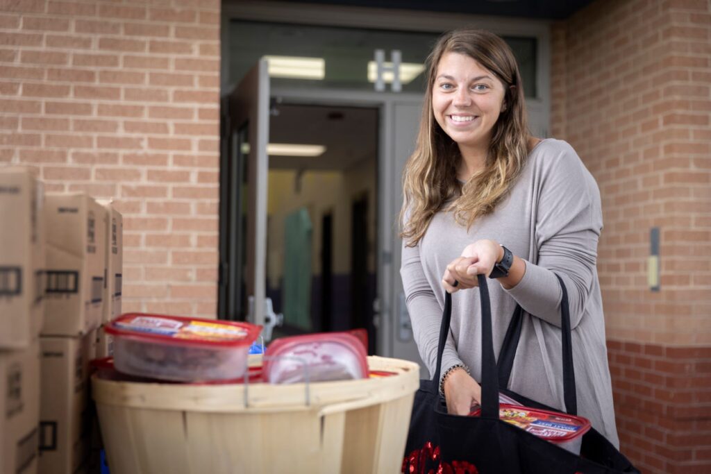 Neighbor receives food at Feed More partner distribution.