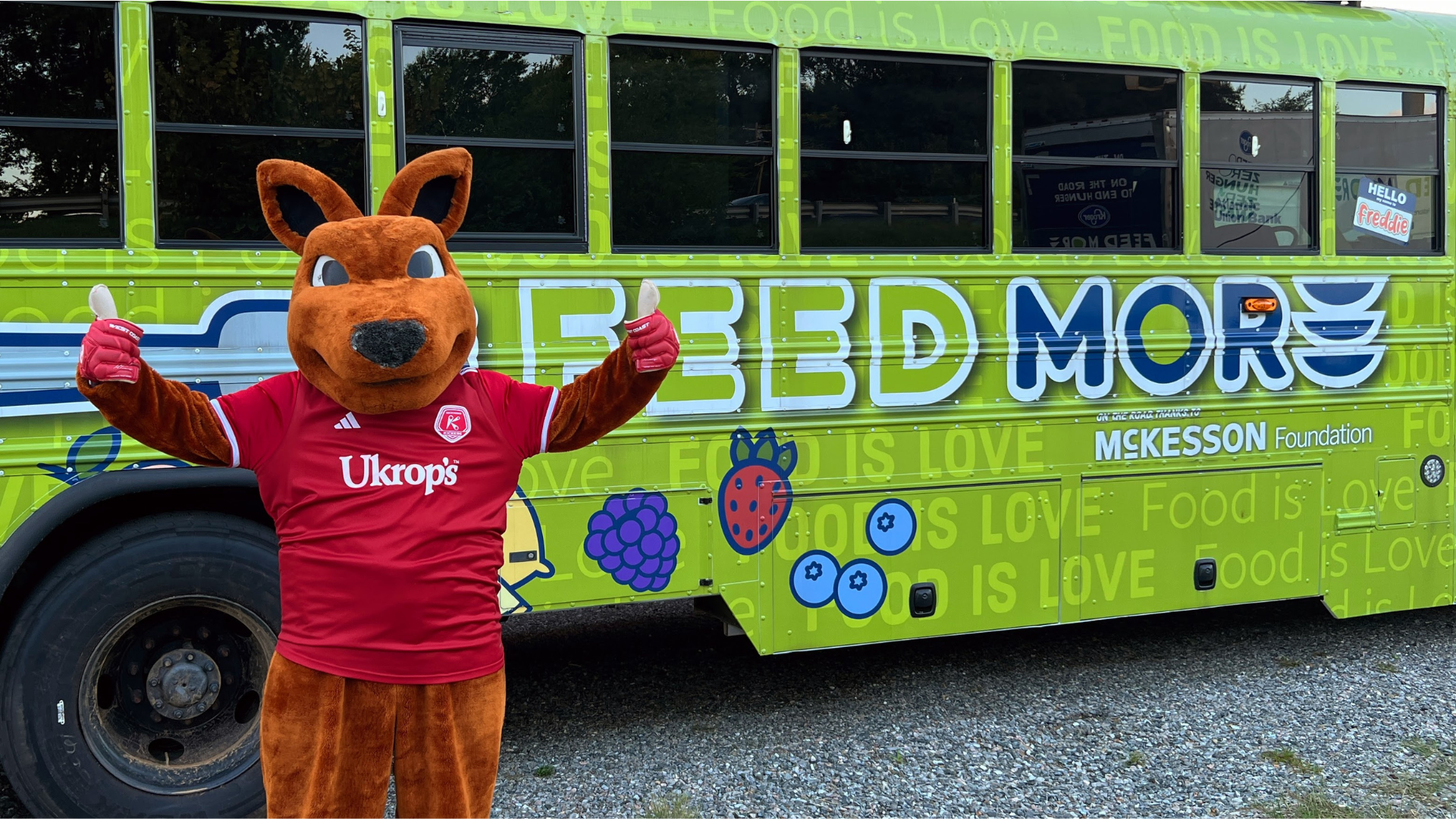 Richmond Kickers mascot Kickeroo stands in front of Feed More's mobile kids market, Feed More Freddie.