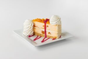 Peach Perfect™ with Raspberry Drizzle. For every slice sold now through July 29 2026, Cheesecake Factory will donate 25 cents to Feed More.