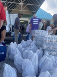 Bags of nonperishable food and bottled water for distribution for displaced Petersburg seniors